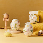 Dinosaur egg scented candle with molded candle opening and colorful dino pattern