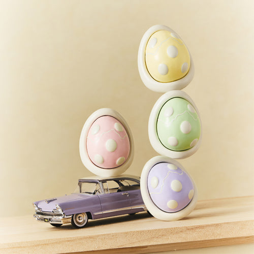 Car diffuser egg scent pods in pastel yellow, green, and purple with white holder