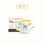 Scented candle in illustrated ceramic cup, label: Aksu Sun