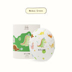 Medog Green dinosaur egg scented candle with colorful dino pattern on round container