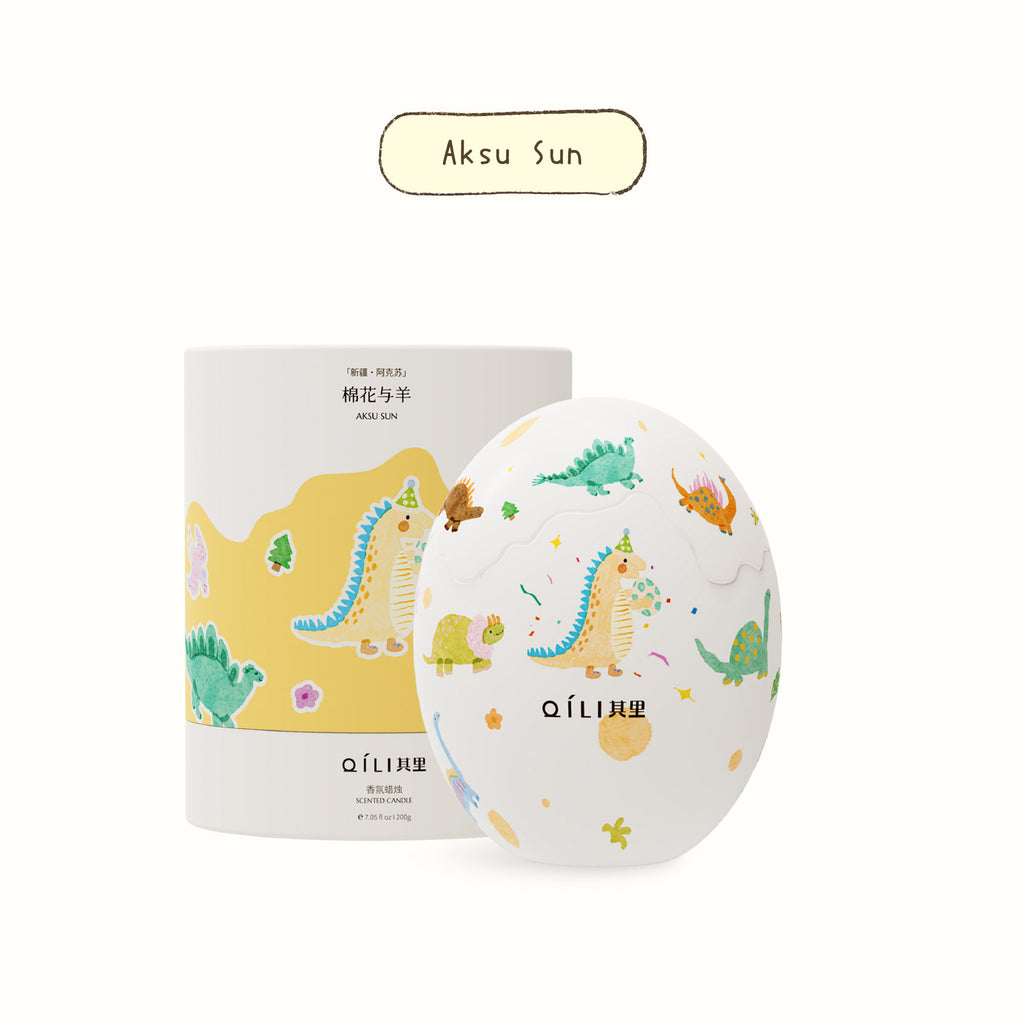 Aksu Sun dinosaur egg scented candle with colorful dino pattern on round container