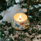 Scented candle in illustrated ceramic cup with flame and light smoke
