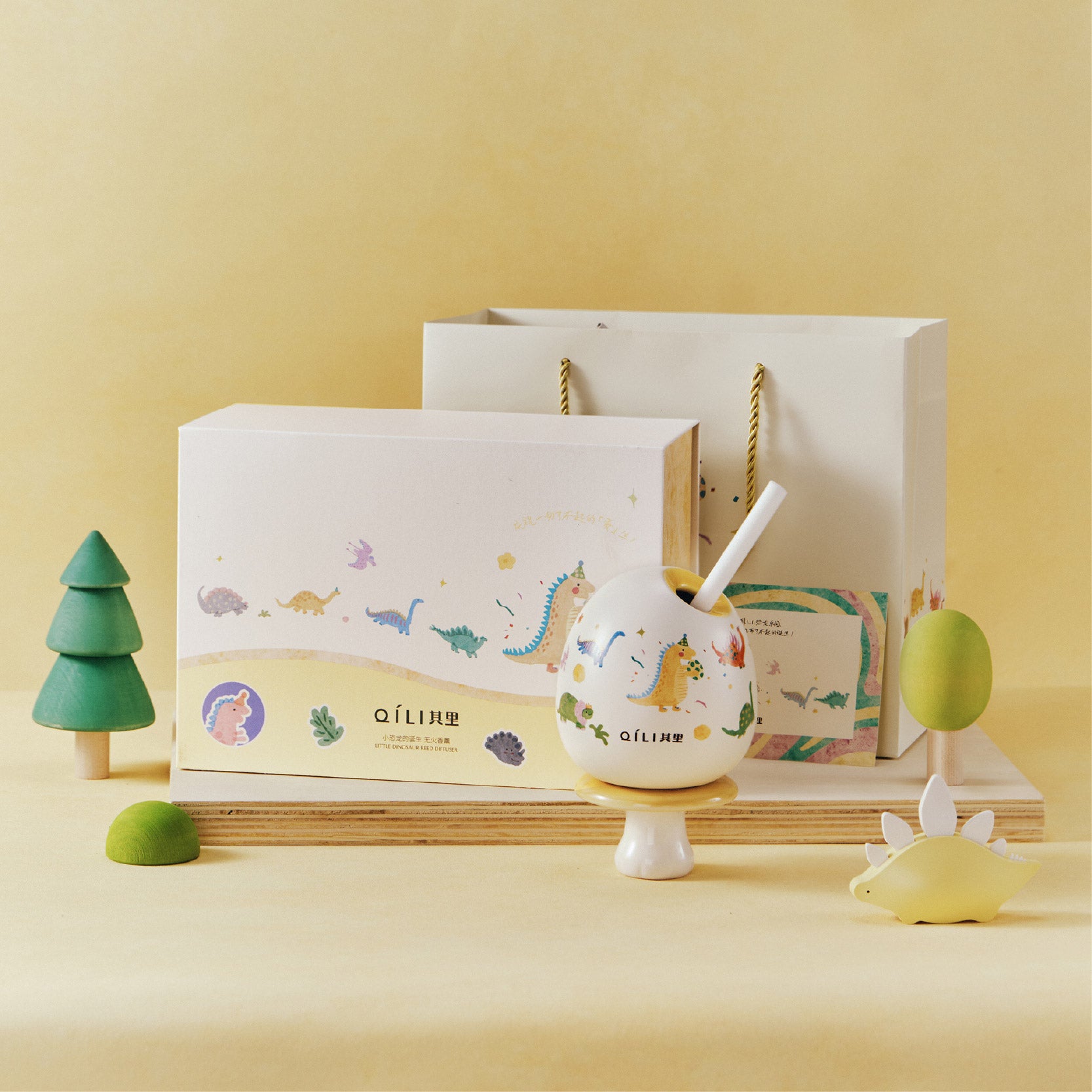 Little dinosaur reed diffuser on display with white globe and straw reed