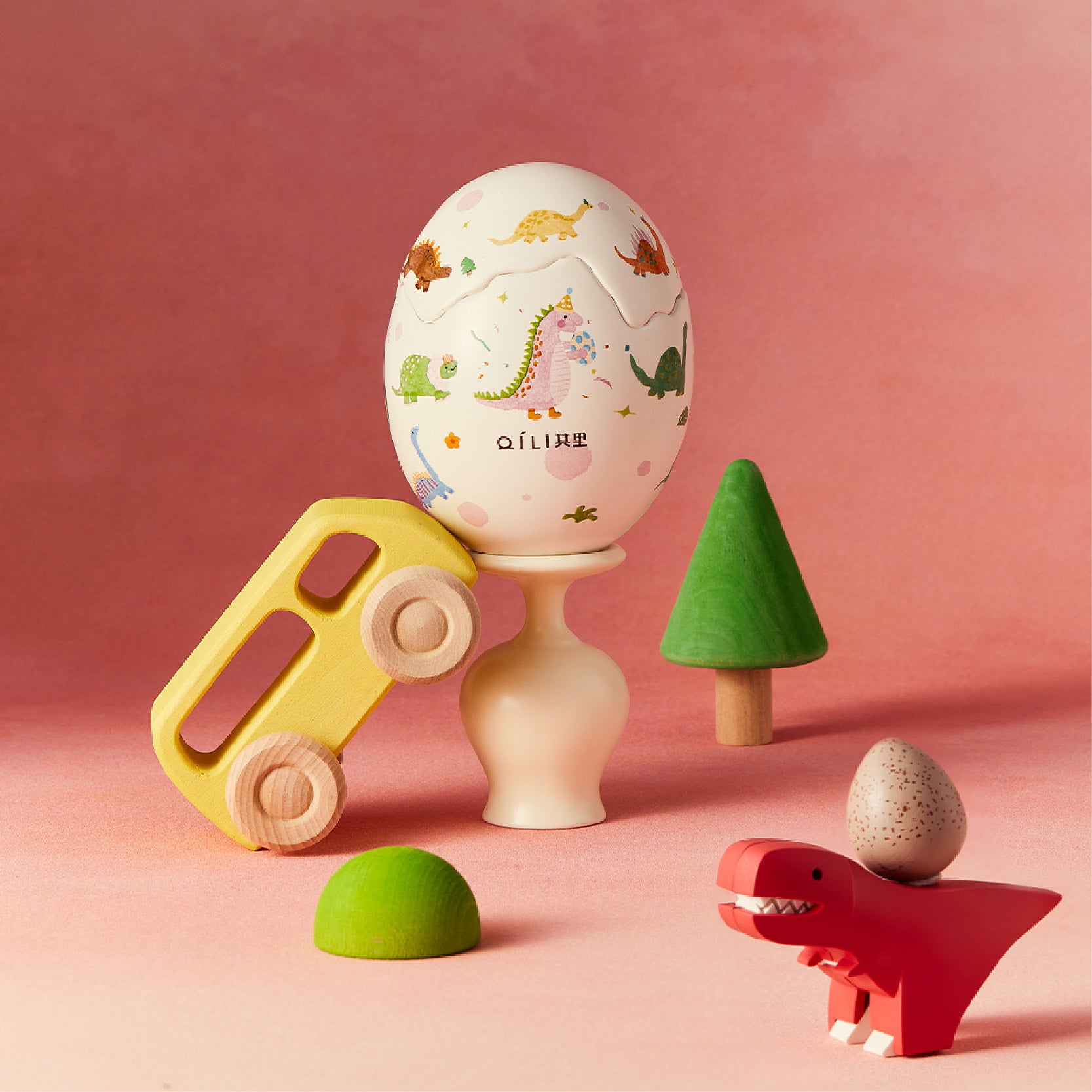 Dinosaur egg scented candle with colorful dino print on white egg-shaped container